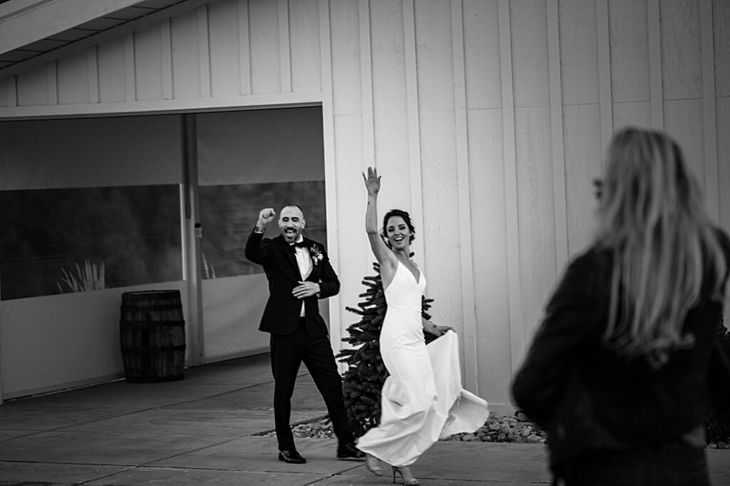 Couple dances while waving to their guests at a wedding in Colorado photographed by Hillary Shedd Photography, Colorado Wedding Photographer